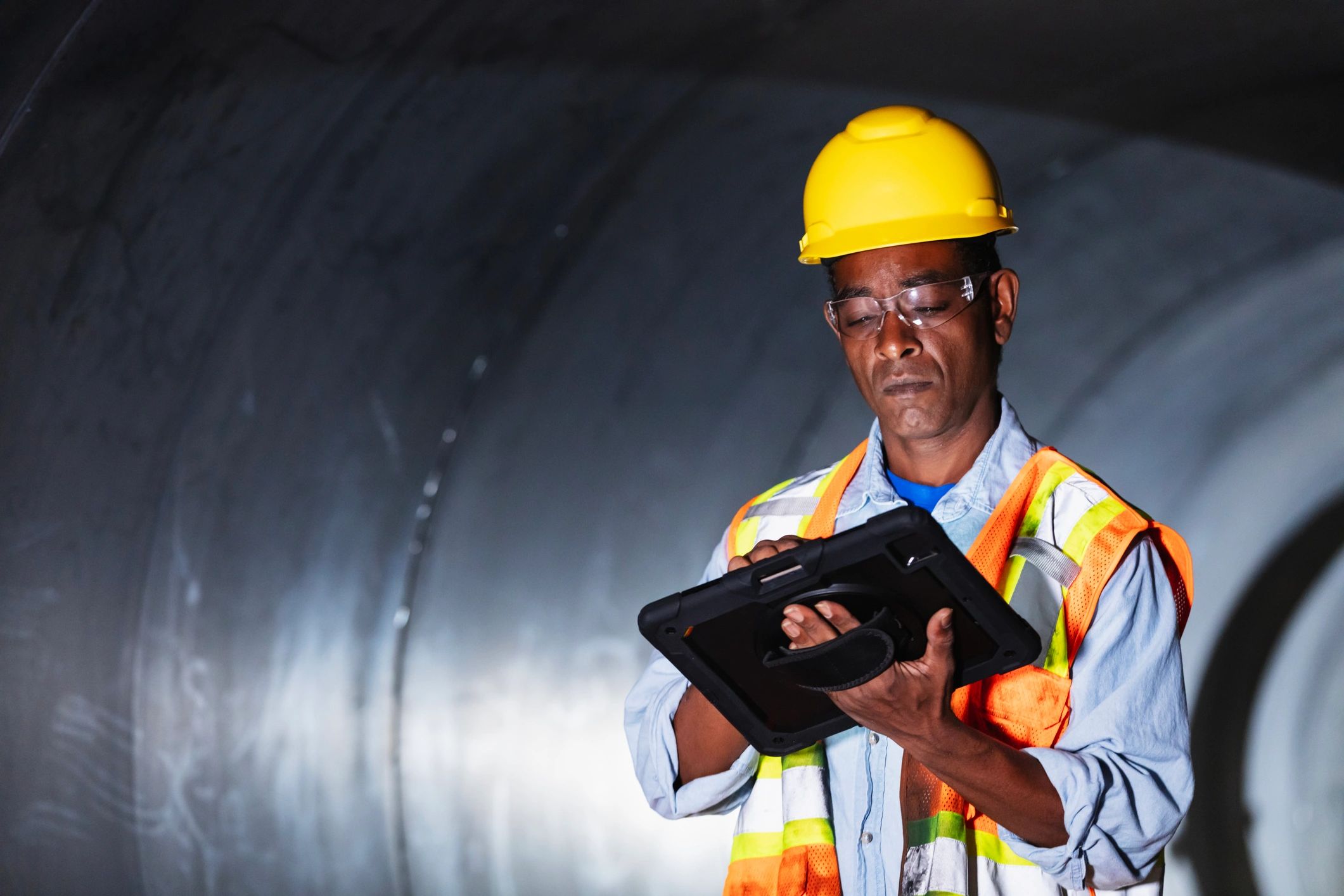 Worker using a digital tablet in an industrial facility