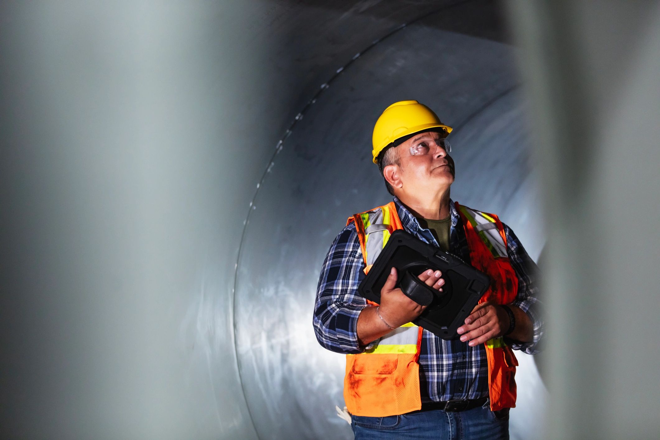 Industrial worker using a tablet in a manufacturing environment
